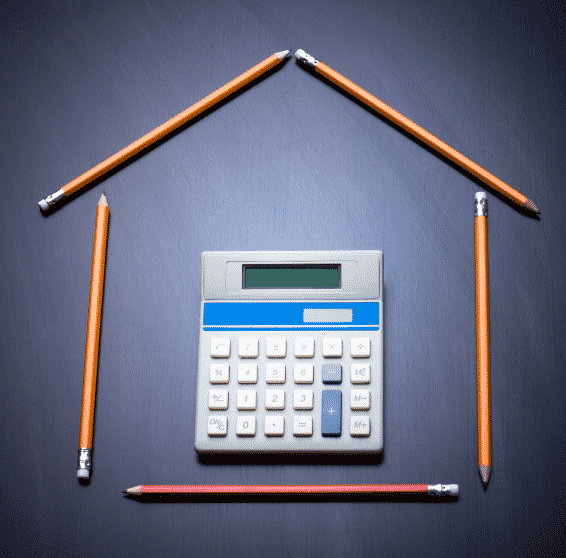 calculator surrounded by pencils in the shape of a house