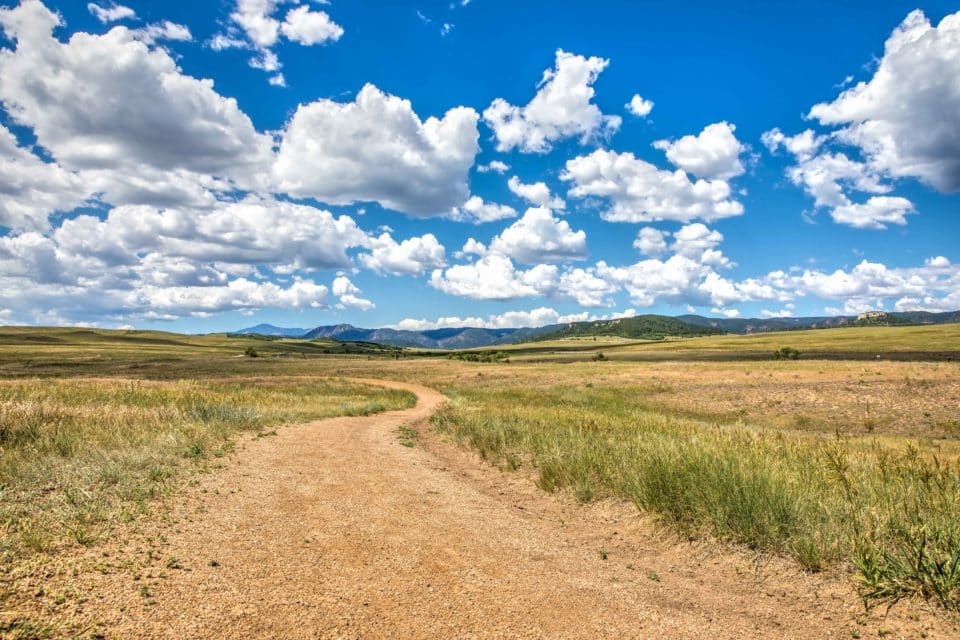 Greenland Open Space with dirt road and clouds with blue sky