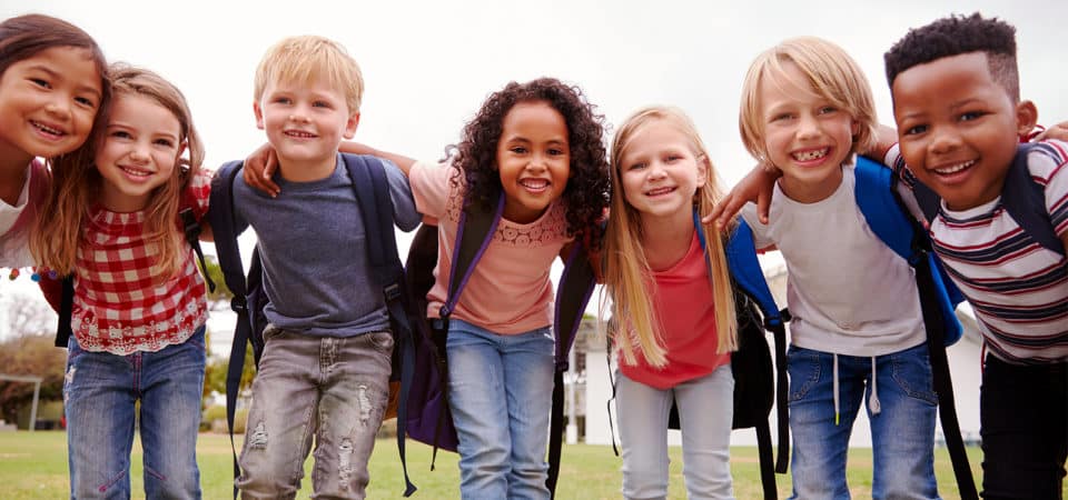 Children with their arms around one another