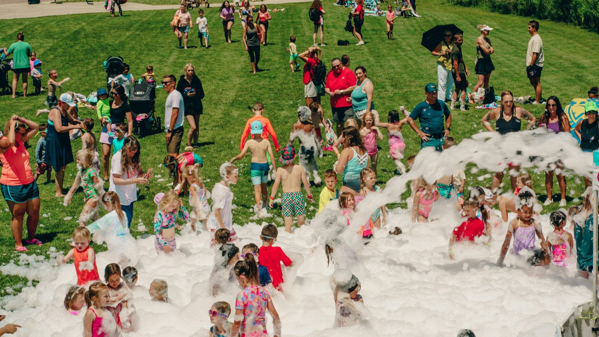 Children playing in foam at the 2025 water festival